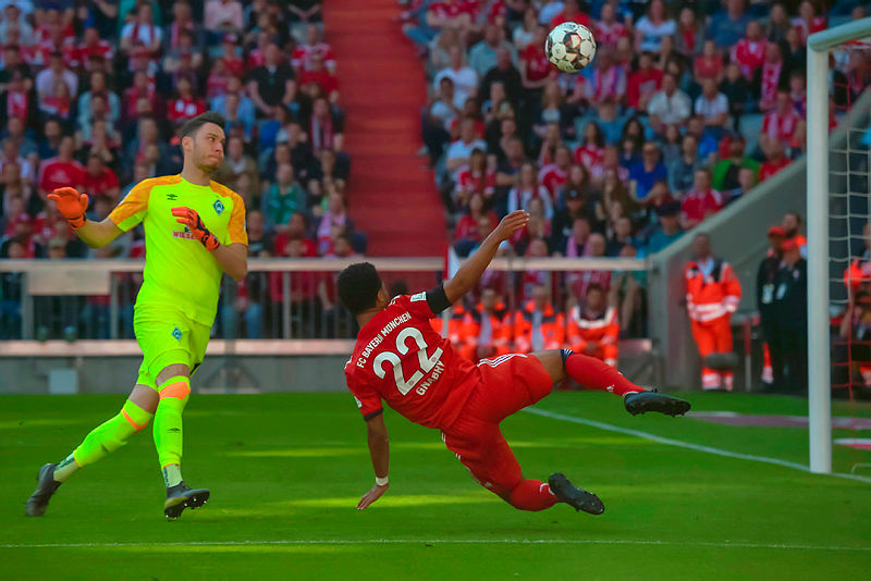 Bremen’s goalkeeper Jiri Pavlenka (L) reacts as Bayern Munich’s Serge Gnabry kicks the ball if front of the goal cage during their Bundesliga match on April 21, 2019 in Munich. — AFP