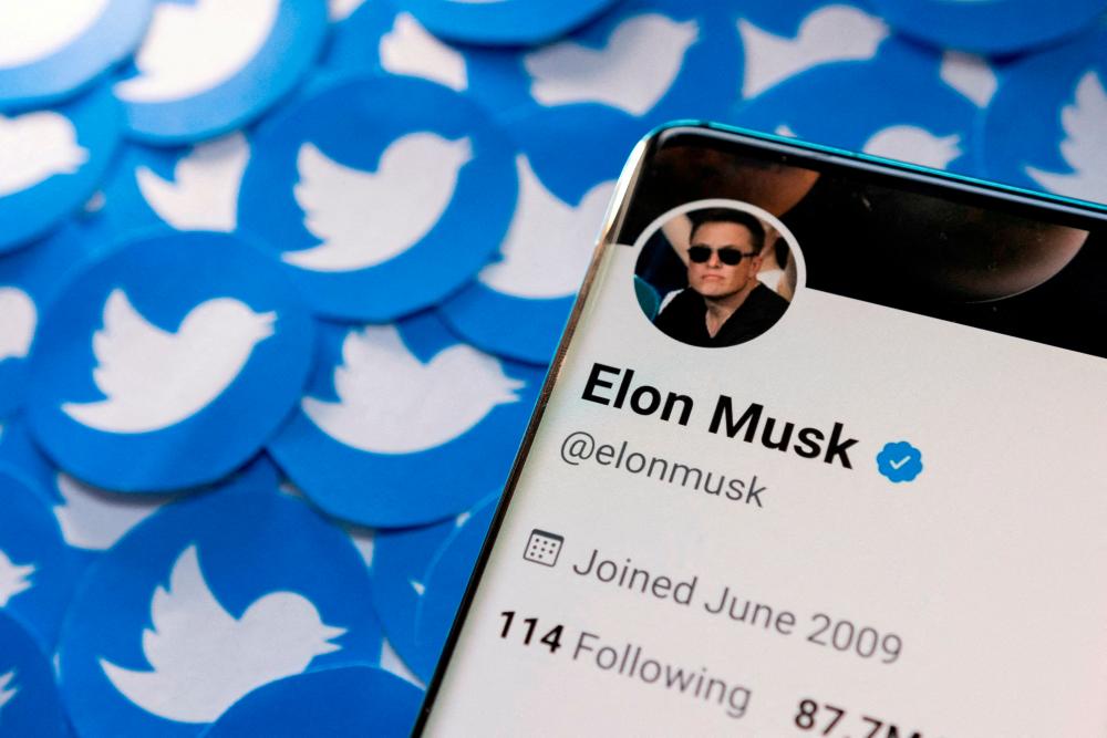 Musk’s Twitter profile is seen on a smartphone placed on printed Twitter logos in this picture illustration. – Reuterspix