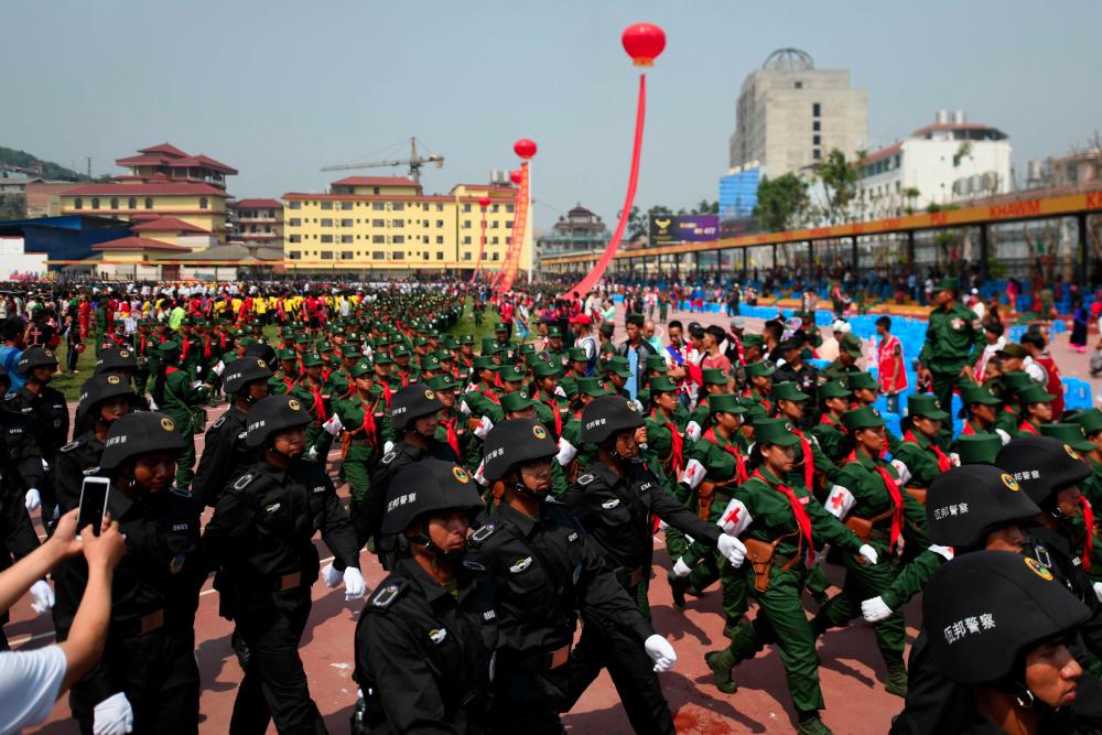 United Wa State Army (UWSA) soldiers and members of a SWAT team participate in a military parade, to commemorate 30 years of a ceasefire signed with the Myanmar military in the Wa State, in Panghsang on April 17, 2019. — AFP