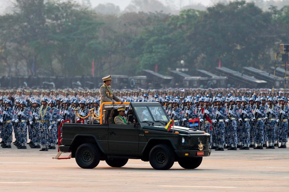 Myanmar’s Chief Senior General Min Aung Hlaing stands in a vehicle as he attends a ceremony to mark the country’s 78th Armed Forces Day in Naypyidaw on March 27, 2023. AFPPIX