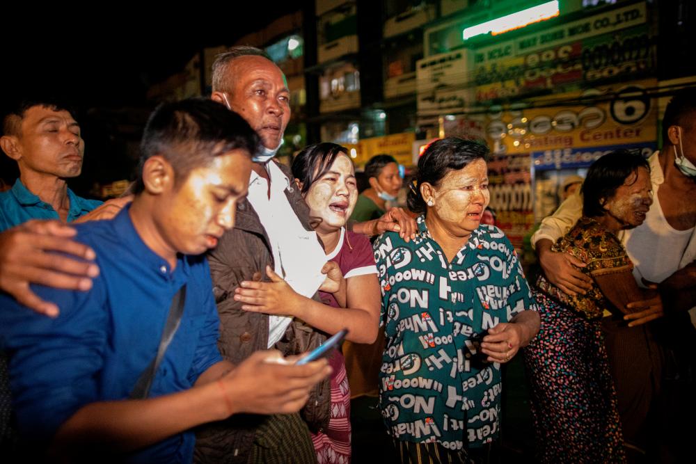 People react outside Insein prison as Myanmar's Junta releases prisoners including people that protested against the military coup, in Yangon, Myanmar October 18, 2021. Picture taken October 18, 2021. REUTERSpix