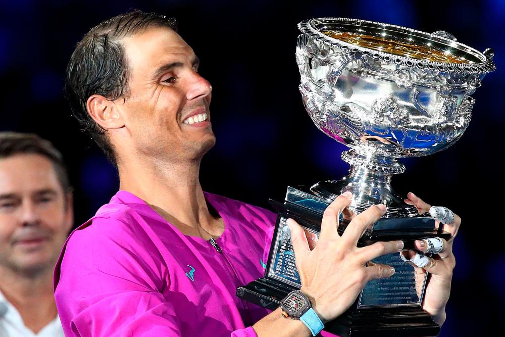 Spain's Rafael Nadal holds the Norman Brookes Challenge Cup trophy following his victory against Russia's Daniil Medvedev in their men's singles final match on day fourteen of the Australian Open tennis tournament in Melbourne on January 31, 2022. AFPPix