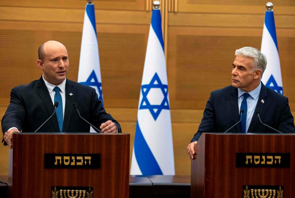 Israel's Prime Minister Naftali Bennett (L) and Foreign Minister Yair Lapid make a joint statement to the press in Jerusalem on June 20, 2022. AFPpix