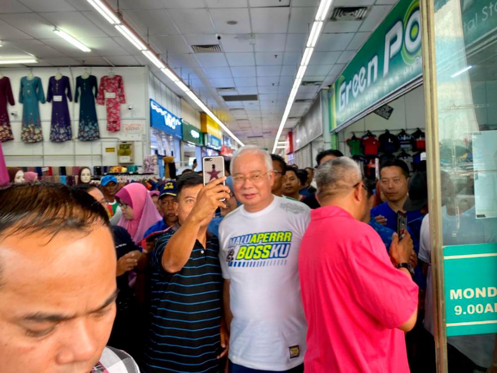 Supporters mob Datuk Seri Najib Abdul Razak, during a walkabout session at Econsave in Pontian, on Nov 9, 2019. — Sunpix by Ikhwan Zulkaflee