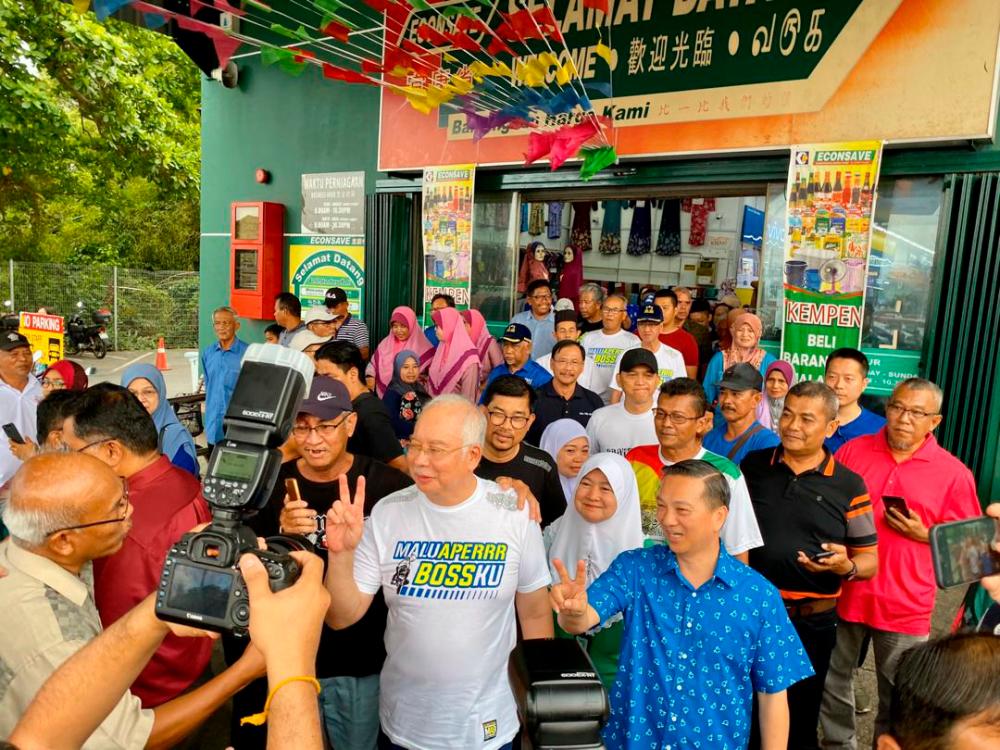 Datuk Seri Najib Abdul Razak and Barisan Nasional’s candidate for the Tanjung Piai by-election, Dr Wee Jeck Seng (R), are mobbed by fans, during a walkabout at the Econsave supermarket, here in Bandar Pontian, on Nov 9, 2019. — Sunpix by Ikhwan Zulkaflee