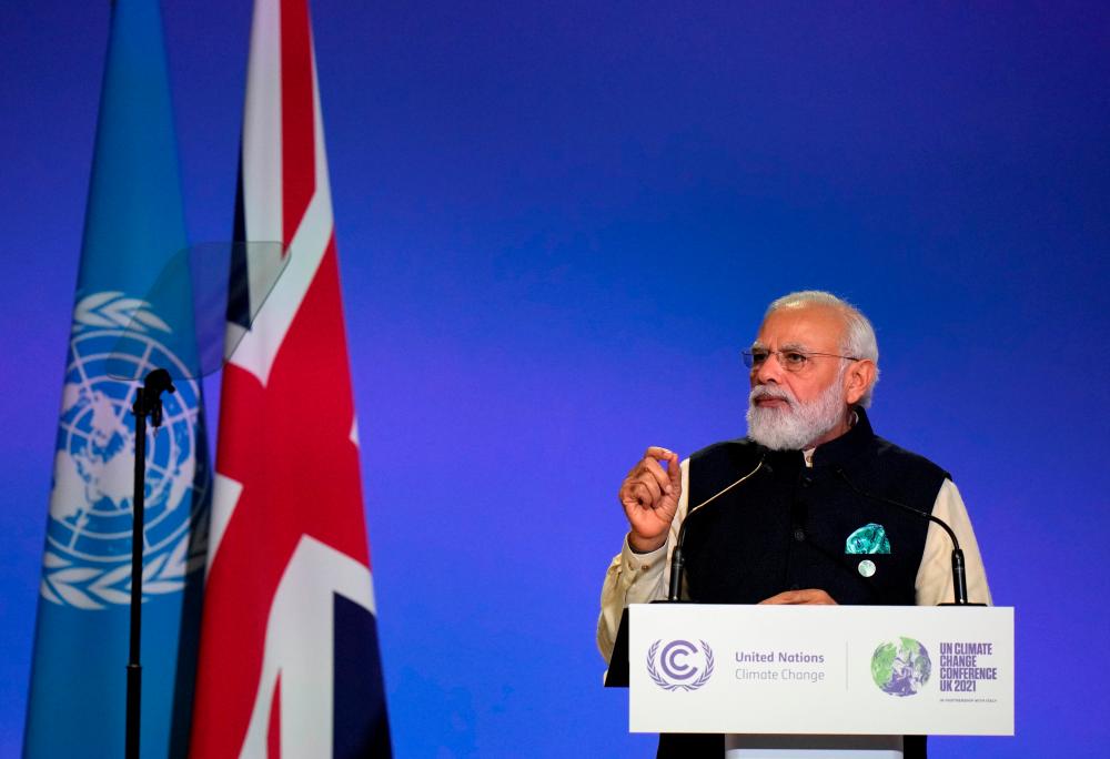 India's Prime Minister Narendra Modi gestures as he makes a statement at the UN Climate Change Conference (COP26) in Glasgow, Scotland, Britain November 1, 2021. Alastair Grant/Pool via REUTERSpix