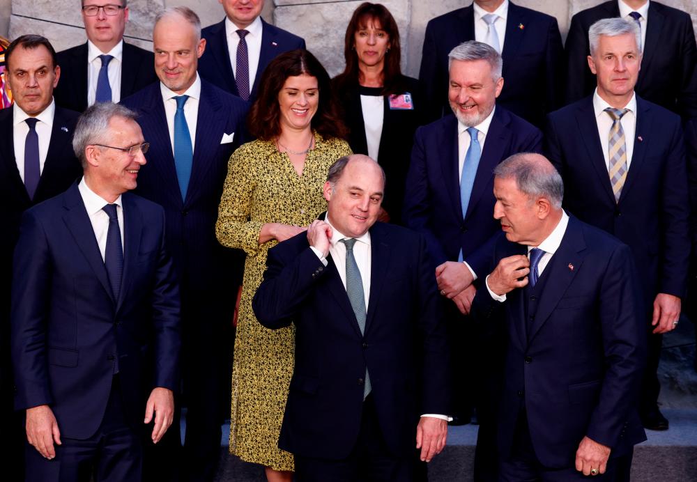 British Defence Secretary Ben Wallace gestures before posing for a family photo with NATO Secretary General Jens Stoltenberg, Turkish Defence Minister Hulusi Akar, Greek Defence Minister Nikolaos Panagiotopoulos, Hungary's Defence Minister Kristof Szalay-Bobrovniczky, Iceland's Defence Minister Thordis Kolbrun Reykfjord Gylfadottir, Portugal's Defence Minister Helena Carreiras, Italy's Defence Minister Lorenzo Guerini, and Latvia's Defence Minister Artis Pabriks, during a NATO defence ministers meeting at the Alliance's headquarters in Brussels, Belgium June 16, 2022. REUTERSpix