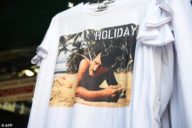 A t-shirt with a picture depicting a nude Adolf Hitler on a beach is on sale at a street market for tourists in Bangkok. — AFP