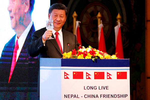 In this handout photo released by the The Rising Nepal newspaper and taken on October 12, 2019 China’s President Xi Jinping (L) speaks during a welcome dinner in Kathmandu. — AFP