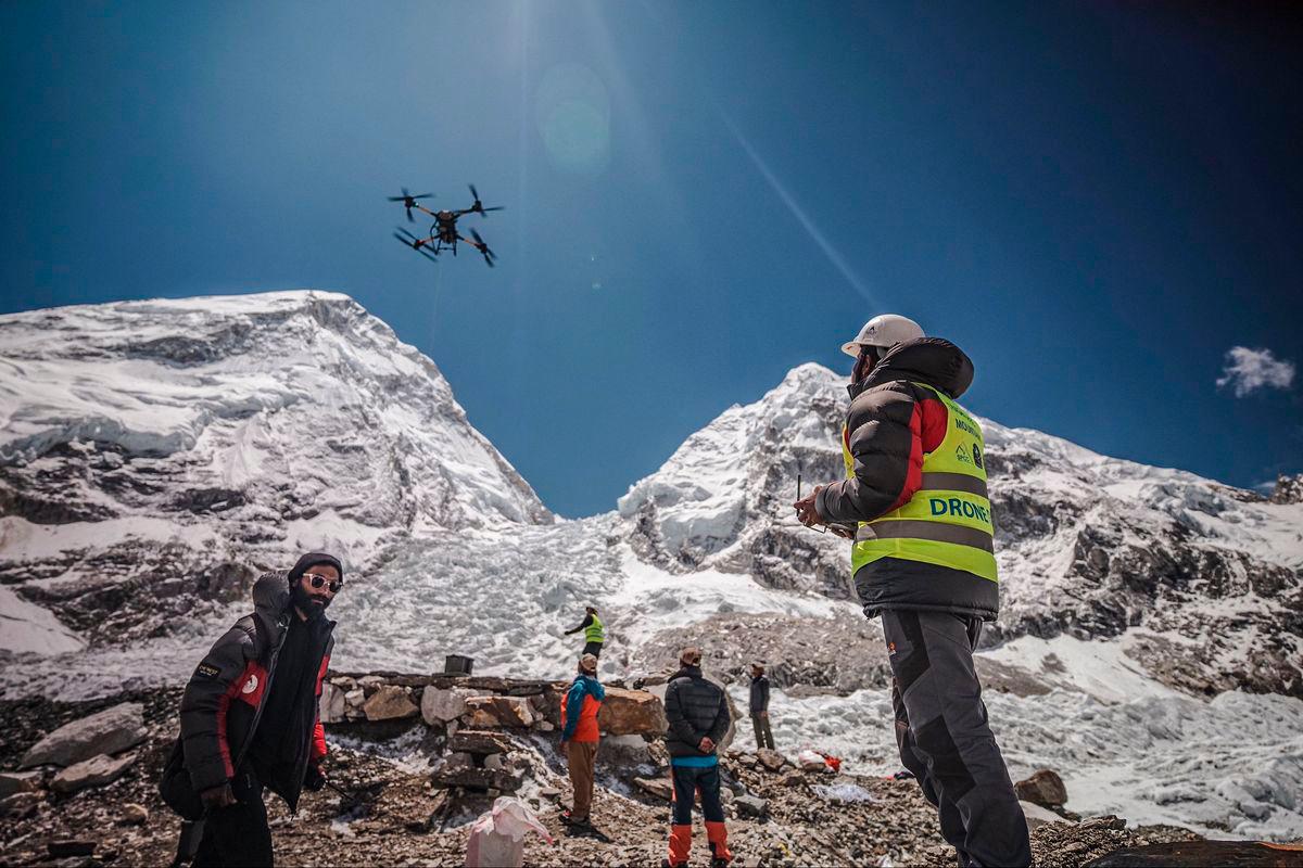 In this handout photograph taken on May 11, 2025 and released by Airlift Technology, a man operates a heavy-lift drone to clear trash dumped at the Everest Base Camp. AFPPix / Airlift Technology