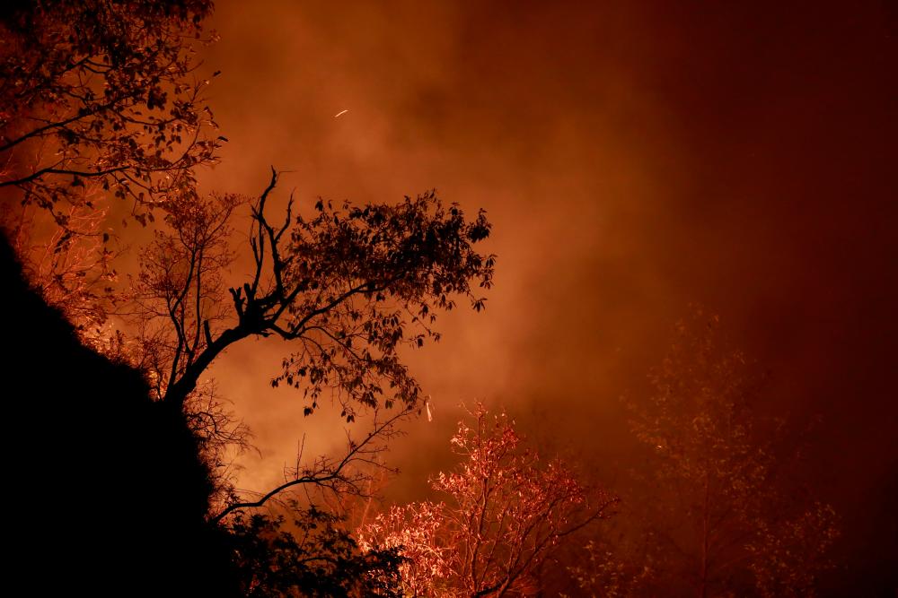 A portion of a hill burns during a forest fire in Makwanpur, outskirts of Kathmandu as forest fires have raged many areas in Nepal contributing to worst air quality in the bowl shaped Kathmandu, Nepal April 8, 2021. — Reuters
