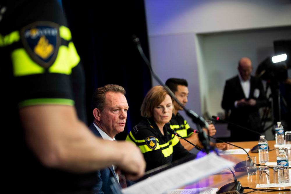 (From L) National Chief Officer Fred Westerbeke, Police Chief of National Unity Jannine van den Berg and Head of National Investigation Andy Kraag give a press conference on the developments surrounding the arrest in Dubai of Ridouan Taghi, in Driebergen, on Dec 16. — AFP