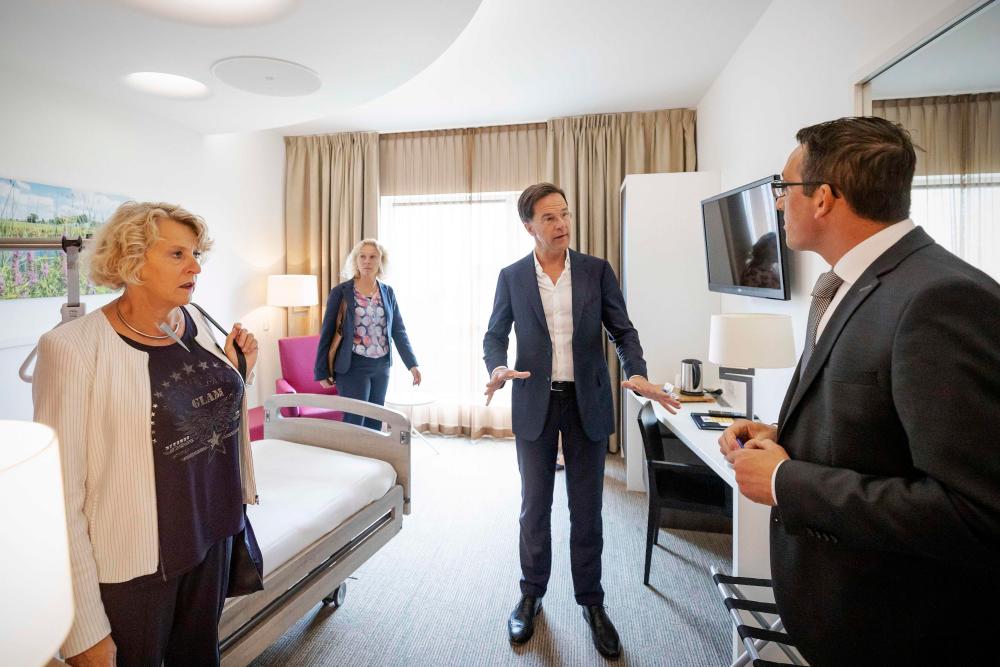 Prime Minister Mark Rutte (C) visits the care hotel, Udens Duyn, where people who have had corona rehabilitate, in Uden on July 15, 2020. — AFP