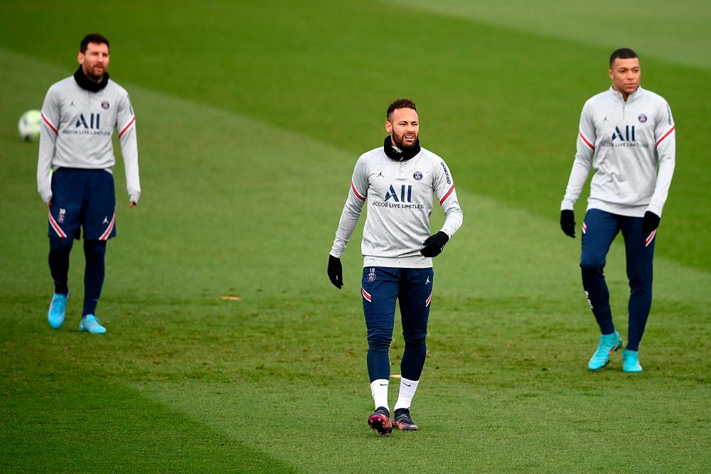 (FromL) Paris Saint-Germain's Argentinian forward Lionel Messi, Paris Saint-Germain's Brazilian forward Neymar and Paris Saint-Germain's French forward Kylian Mbappe walk on the pitch during a training session at the Camp des Loges Paris Saint-Germain football club's training ground, in Saint-Germain-en-Laye, west of Paris on February 10, 2022. AFPPix