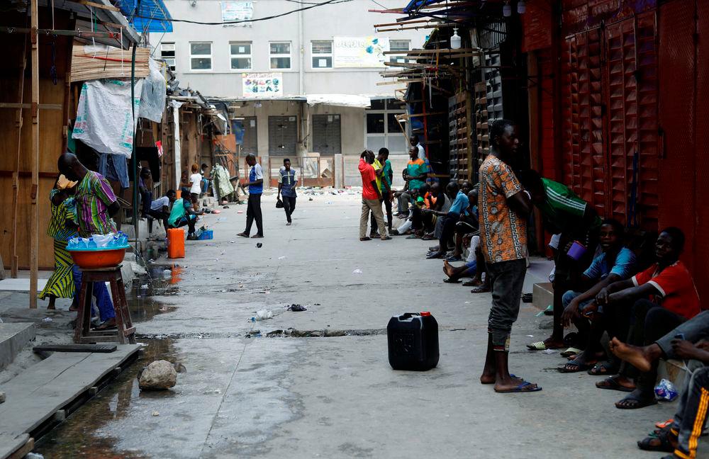 People sit at closed market, as Nigeria’s Lagos state eases a round-the-clock curfew imposed in response to protests against alleged police brutality, after days of unrest, in Lagos, Nigeria October 24, 2020. — Reuters