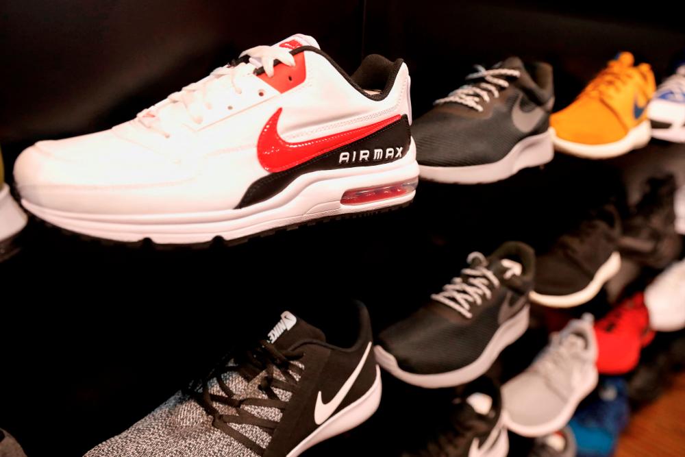 Nike shares tumble as it reports lower earnings