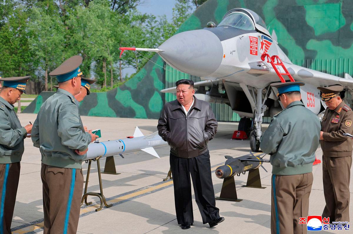North Korean leader Kim Jong Un (C) beside a MiG-29 aircraft and air-launched weaponry on display during anti-air combat and air raid drills by the Guards 1st Air Division of the North Korean Army at an undisclosed location in North Korea. AFPpix