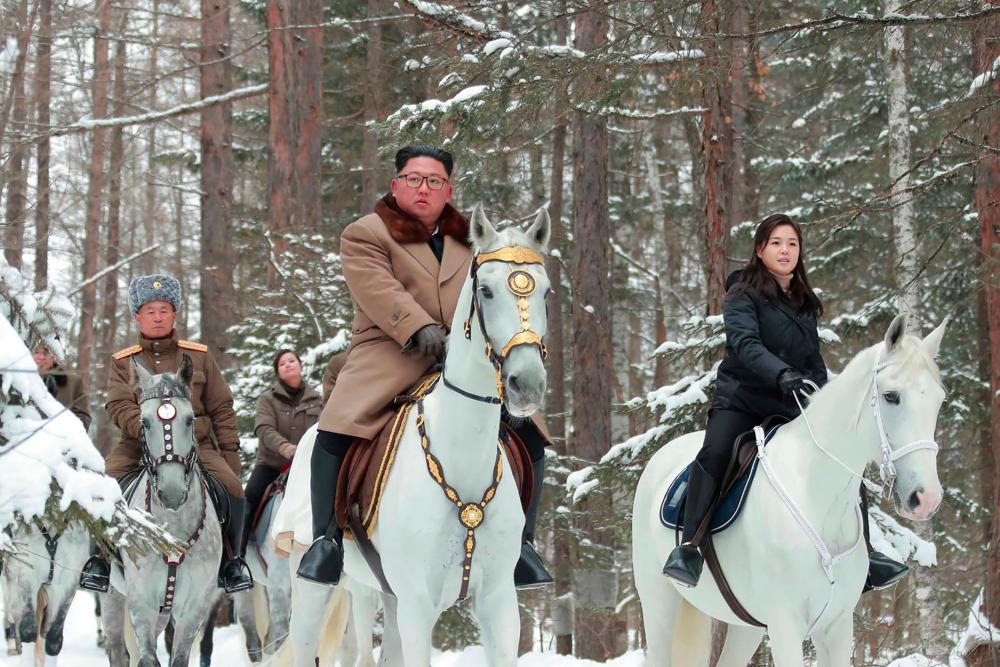This undated picture released from North Korea's official Korean Central News Agency (KCNA) on Dec 4, shows North Korean leader Kim Jong Un (C) riding a horse as he visits battle sites at Mount Paektu, Ryanggang. — AFP