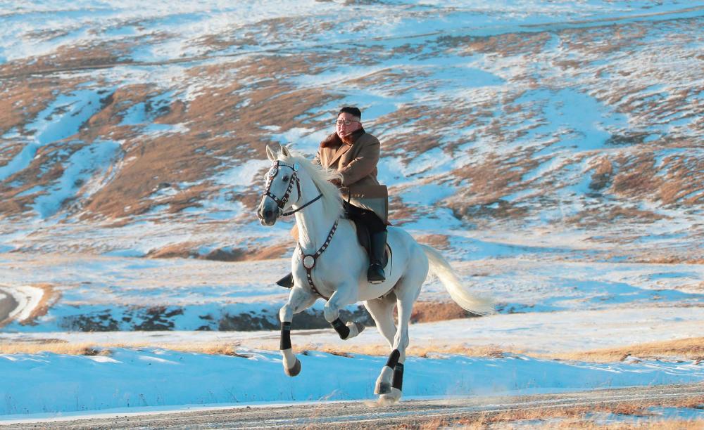 This undated picture released by Korean Central News Agency on October 16, 2019 shows North Korean leader Kim Jong Un riding a white horse amongst the first snow at Mouth Paektu. - AFP
