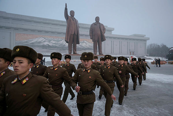 Korean People’s Army (KPA) soldiers leave after bowing before the statues of late North Korean leaders Kim Il Sung and Kim Jong Il during National Memorial Day on Mansu Hill in Pyongyang on Dec 17, 2018. — AFP