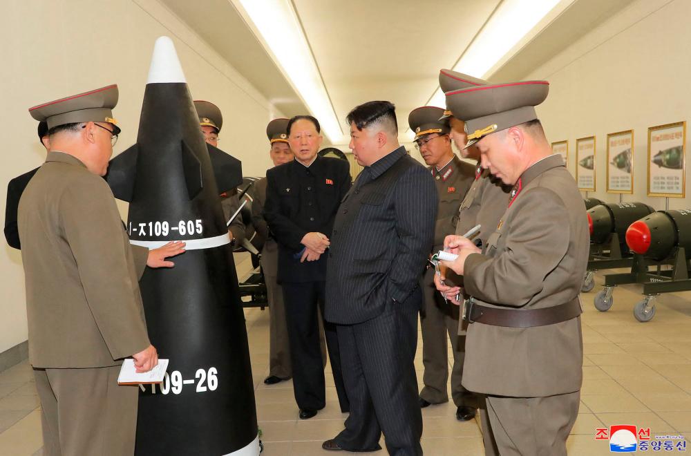 This picture taken on March 27, 2023 and released by North Korea’s official Korean Central News Agency (KCNA) on March 28, 2023 shows North Korean leader Kim Jong Un (2nd L) inspecting a nuclear weaponisation project at an unknown location in North Korea. AFPPIX