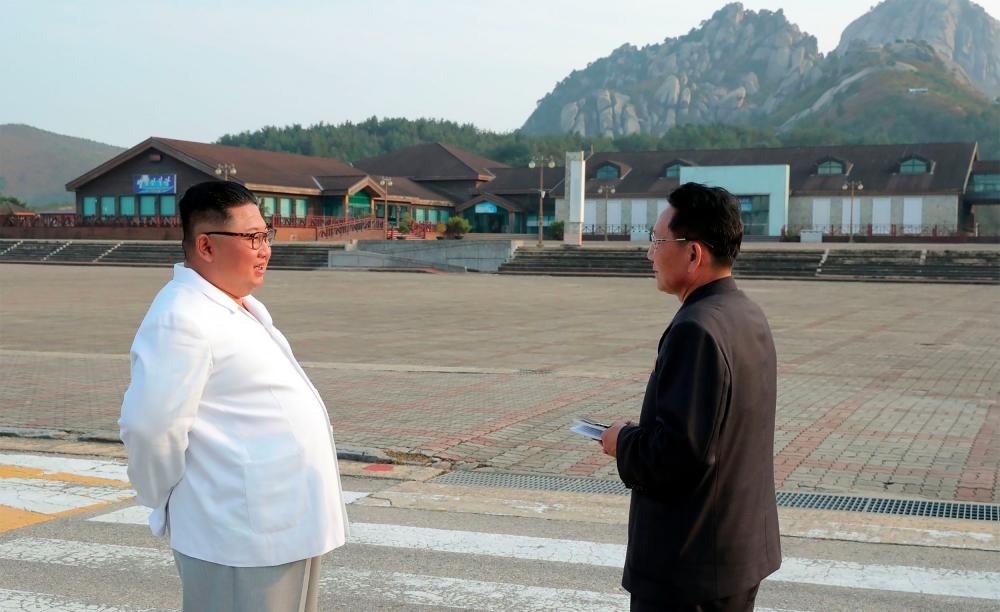 This undated picture released from North Korea's official Korean Central News Agency (KCNA) on Oct 23, 2019 shows North Korean leader Kim Jong Un (L) inspecting the Mount Kumgang tourist area. — AFP