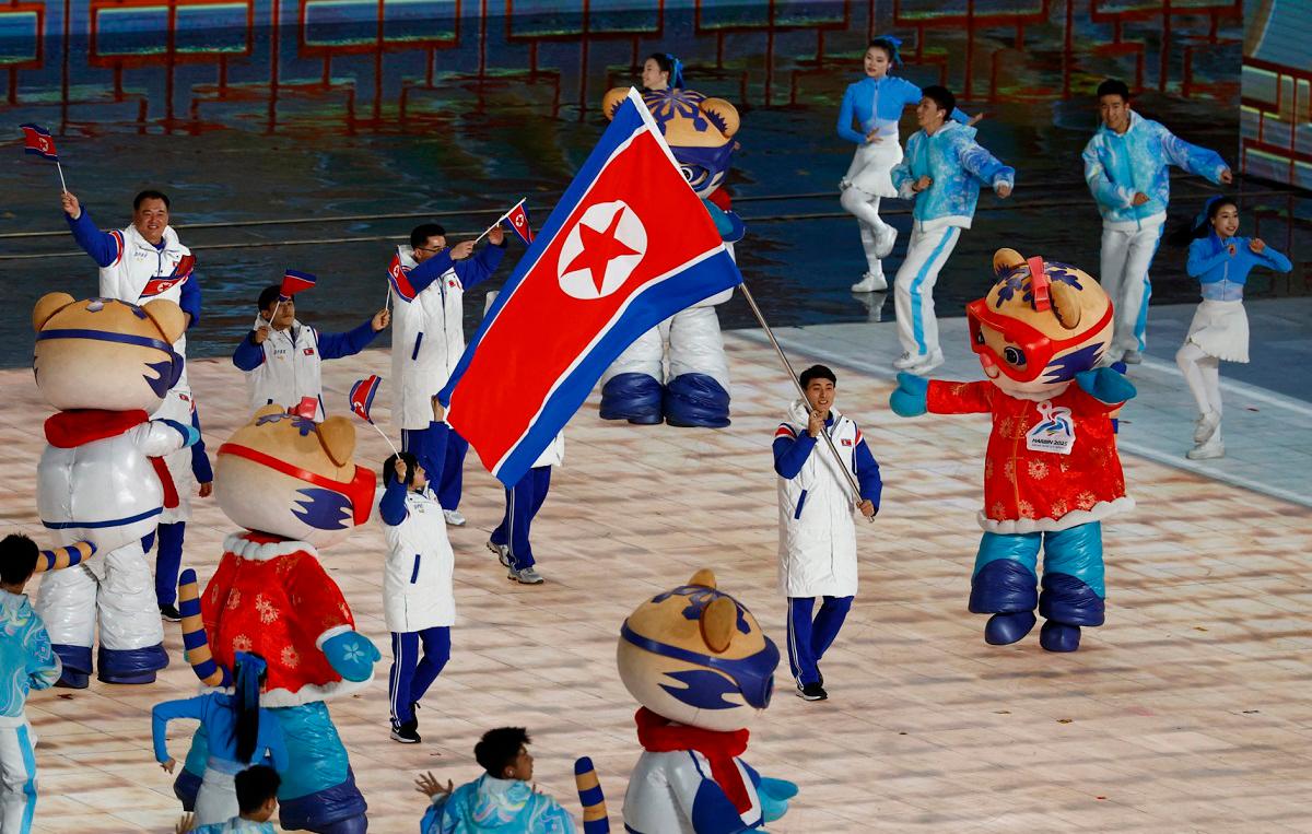 North Korea's flag bearer leads their contingent during the parade of athletes at the opening ceremony of the Harbin 2025 Asian Winter Games in Harbin, northeast China's Heilongjiang province on February 7, 2025. - Issei Kato / POOL / AFP