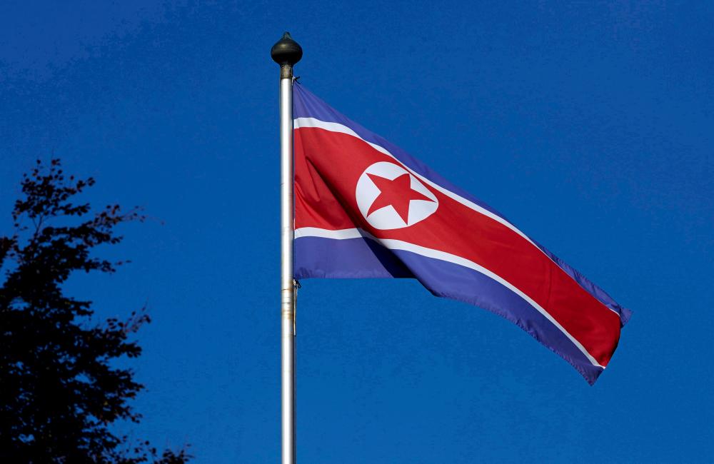 FILE PHOTO: A North Korean flag flies on a mast at the Permanent Mission of North Korea in Geneva October 2, 2014. REUTERSpix