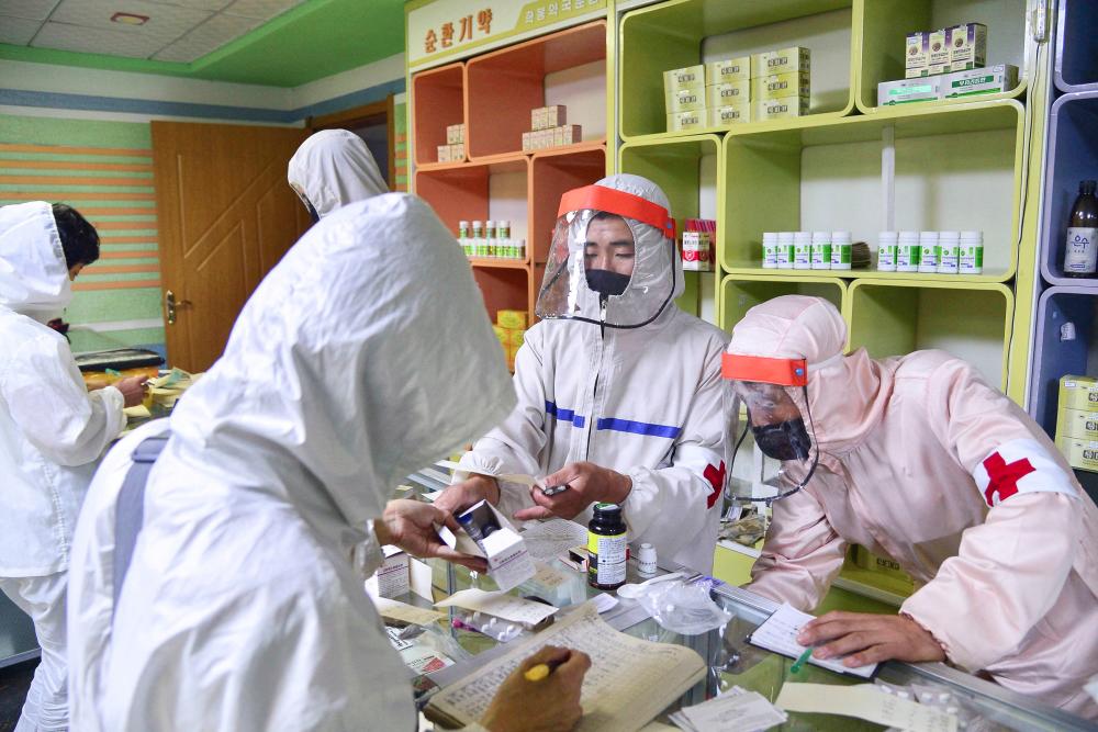 Members of the North Korean army supply medicines to residents at a pharmacy, amid growing fears over the spread of the coronavirus disease (Covid-19), in Pyongyang, North Korea, in this photo released by Kyodo on May 18, 2022. Mandatory credit Kyodo/via REUTERSpix