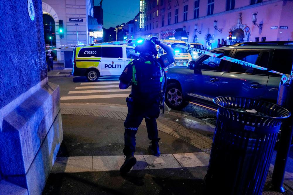 Police secure the area after a shooting in Oslo on June 25, 2022. Two people were killed and several others seriously wounded in a shooting in central Oslo, Norwegian police said on June 25. - AFPPIX