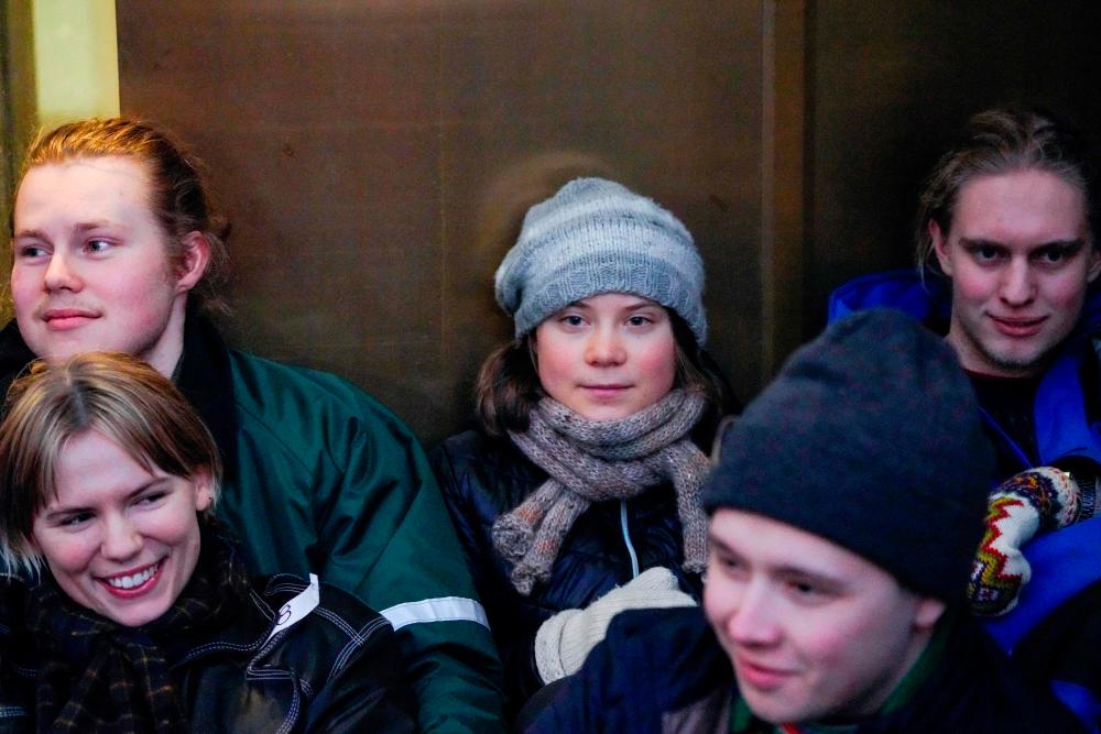 Sweden’s Greta Thunberg (C) and other young climate activists from the “Nature and Youth” and “Norwegian Samirs Riksforbund Nuorat” groups block the entrance of Norway’s Energy ministry as they protest against wind turbines built on land traditionally used to her reindeer, in Oslo, on February 27, 2023. AFPPIX