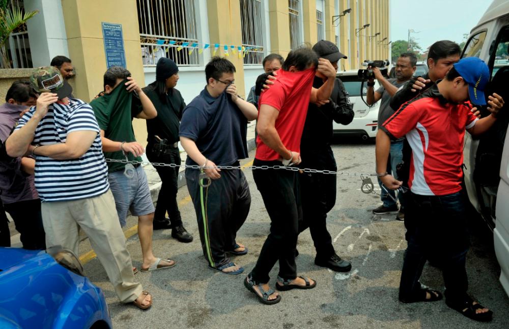 Twenty individuals including a senior immigration officer were charged at the sessions court, in Penang, on Sept 12, 2019.