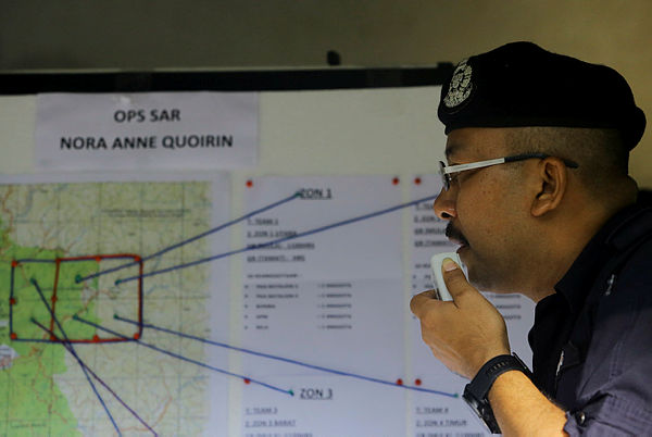 Nilai district police chief Supt Mohd Nor Marzukee Besar inspects a map containing information on the search for missing Irish teenager, Nora Anne Quoirin, 15, who was reported missing on Sunday. — Bernama