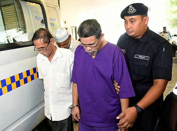 Three men Rahmat Umar, 56, (2nd from L), Hashim Munting, 59, (L) and Ismail Rahaman, 58, (2nd from R) were charged in the Seremban sessions court on charges of migrant smuggling in Port Dickson in January and February. — Bernama