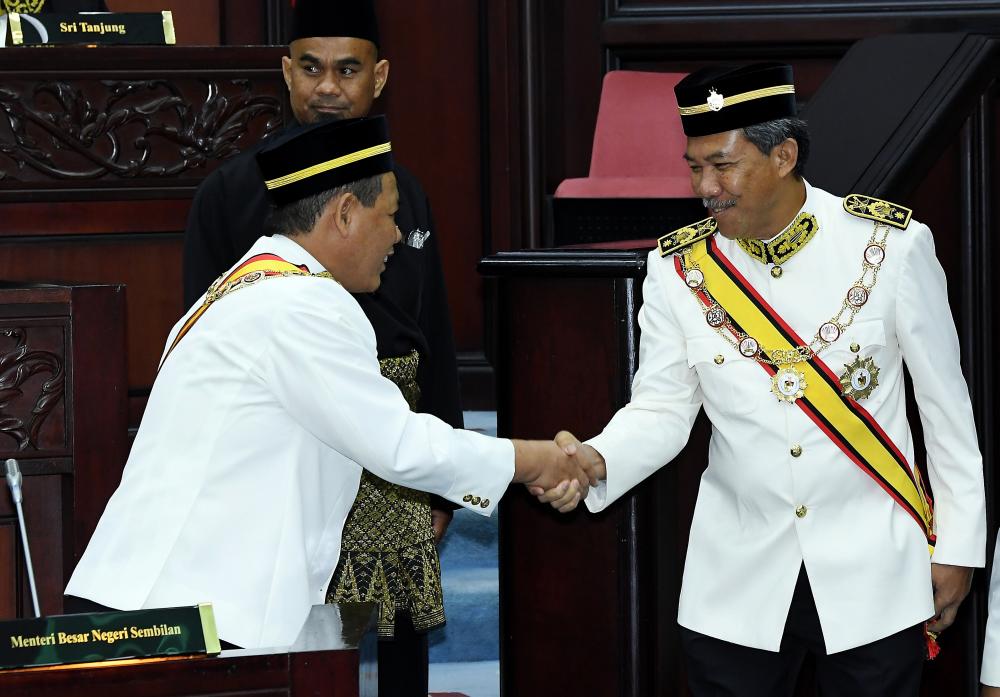 Mentri Besar Datuk Seri Aminuddin Harun (L) congratulates Rantau assemblyman Datuk Seri Mohamad Hasan during the 14th General Assembly of the 14th State Legislative Assembly on April 22, 2019. — Bernama