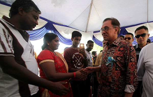 Port Dickson MP Datuk Seri Anwar Ibrahim, who also serves as PKR president, shakes hands with members of the public at the Port Dickson Ponggal Festival 2019 at Bandar Springhill, Port Dickson on Feb 24, 2019. — Bernama