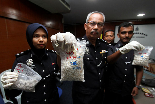 Port Dickson District Police chief Supt Aidi Sham Mohamed and other police personnel show off some of the seized heroine and syabu, during a press conference at Port Dickson District Police Headquarters on Feb 15, 2019. — Bernama