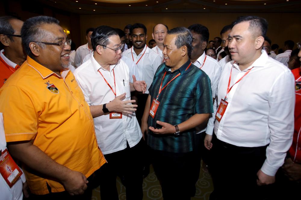 DAP secretary-general Lim Guan Eng (2nd L), Negri Sembilan Mentri Besar Datuk Seri Aminuddin Harun (2nd R), and Transport Minister Anthony Loke Siew Fook, during the state DAP’s annual convention, in Seremban, on Sept 22, 2019. — Bernama