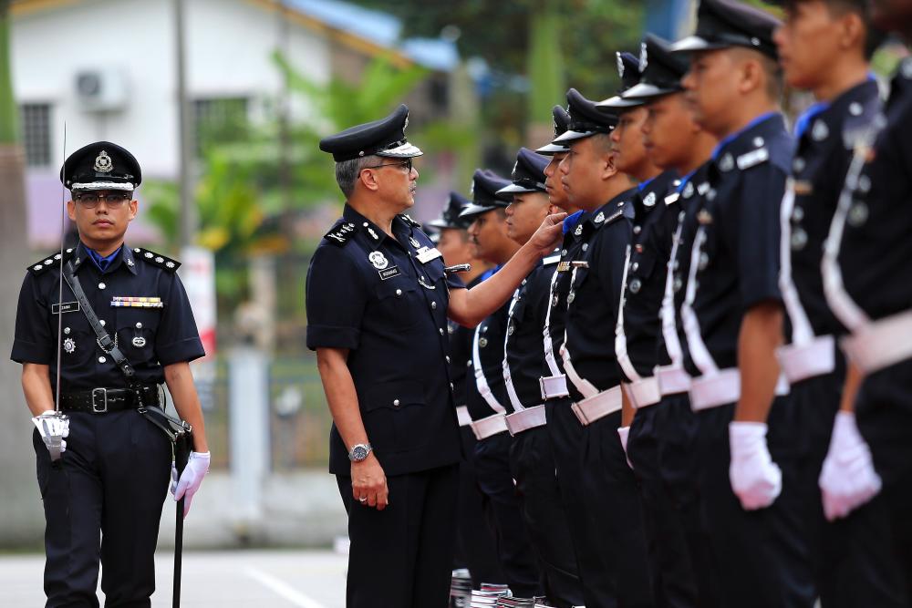 Negri Sembilan Police chief DCP Datuk Mohamad Mat Yusop inspects the honour guard of police personnel during the monthly assembly of the Negri Sembilan Police Contingent today. - Bernama