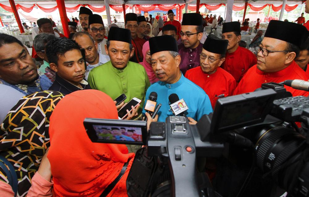 Bersatu president Tan Sri Muhyiddin Yassin (C) responds to a question from a journalist at the Negri Sembilan PH-Bersatu Aidilfitri celebration in Kuala Klawang today. - Bernama