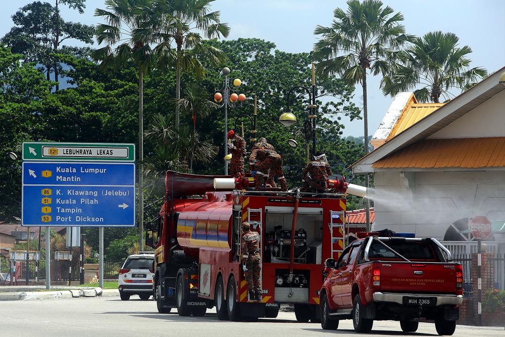 A Hazmat team of the Negri Sembilan Fire and Rescue Department carry out disinfection operations in Seremban today. - Bernama