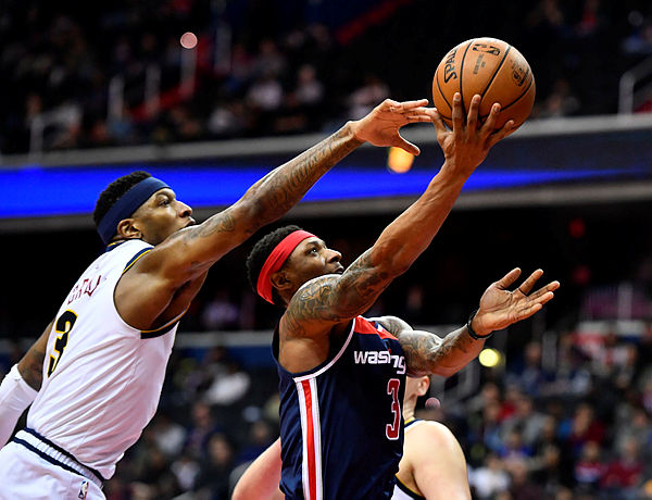 Washington Wizards guard Bradley Beal (3) shoots as Denver Nuggets forward Torrey Craig (3) defends during the second half at Capital One Arena. — Reuters
