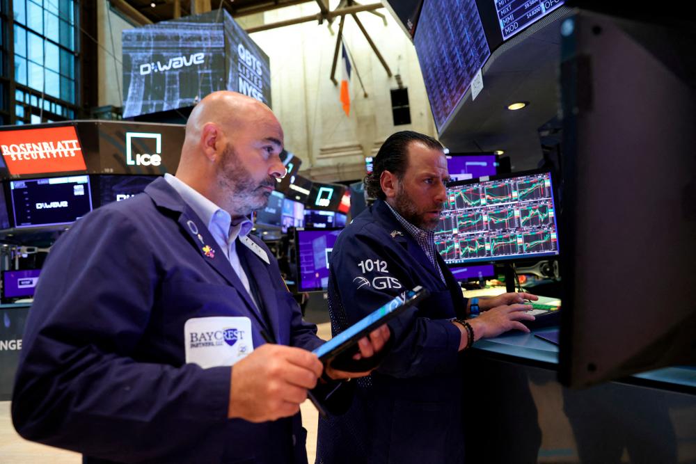 Traders working on the trading floor at the New York Stock Exchange. – Reuters