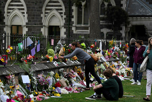 Residents pay their respects for the victims of the mosques attacks in Christchurch on March 16, 2019. — AFP