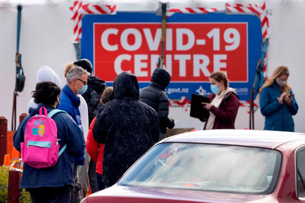 People visit a Covid-19 testing station during a nationwide lockdown in Wellington on August 18, 2021. -AFP
