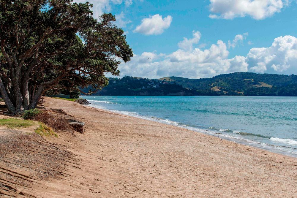 A deserted beach is pictured following a tsunami warning in Orewa, north of Auckland, on March 5, 2021, as tens of thousands of coastal residents in New Zealand, New Caledonia and Vanuatu fled for higher ground as a cluster of powerful earthquakes sparked a Pacific-wide tsunami alert. - AFP