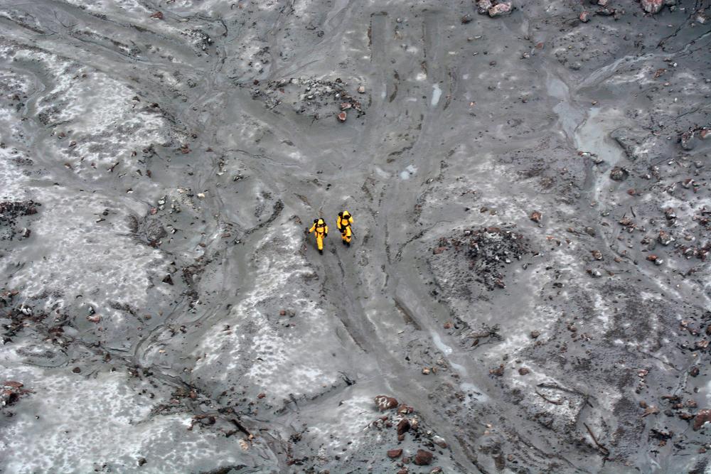 This handout aerial photo taken and released on Dec 13, by the New Zealand Defence Force shows elite soldiers taking part in a mission to retrieve bodies from White Island after the Dec 9 volcanic eruption, off the coast from Whakatane on the North Island. — AFP