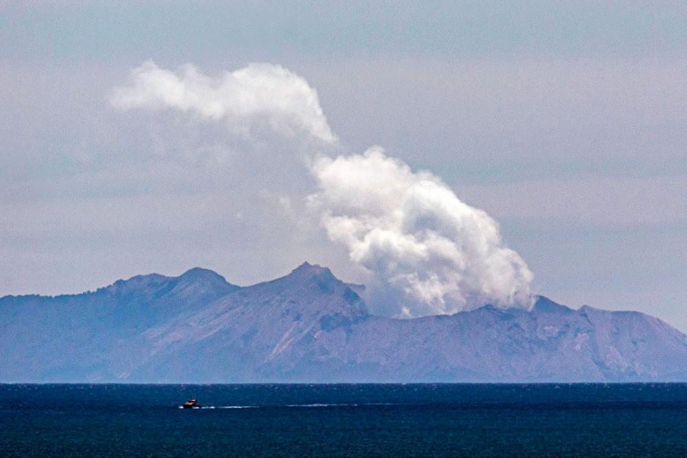 Steam rises from the White Island volcano following the Dec 9 volcanic eruption, in Whakatane on Dec 11. — AFP