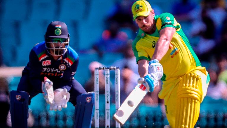 Australia’s captain Aaron Finch (right) hits a six as India’s wicketkeeper KL Rahul watches during the one-day international cricket match at the Sydney Cricket Ground (SCG). – AFPPIX