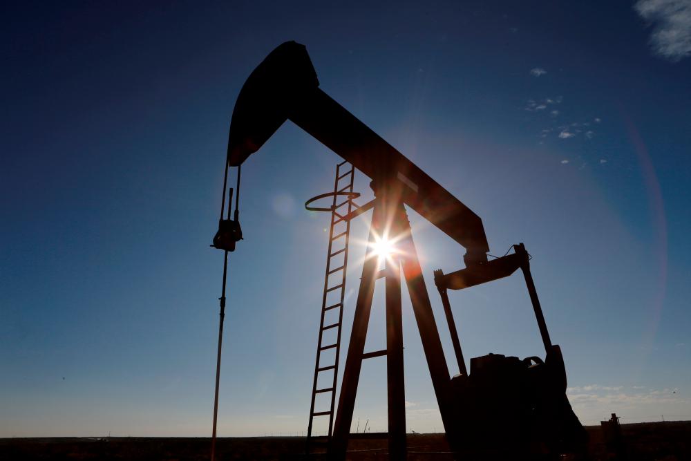 The sun is seen behind a crude oil pump jack in Texas, USA. – REUTERSPIX
